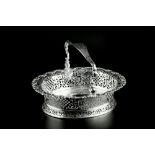 A GEORGE II SILVER SWING HANDLED OVAL CAKE BASKET, the sides with lattice and foliate pierced