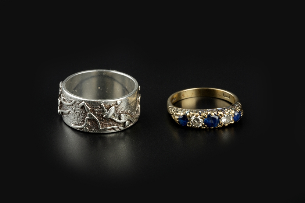 A SAPPHIRE AND DIAMOND FIVE STONE RING, alternately set with circular mixed-cut sapphires and