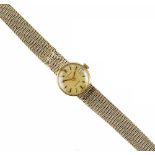A LADY'S 9CT GOLD AUTOMATIC BRACELET WATCH BY LONGINES, the circular gilt dial with baton markers