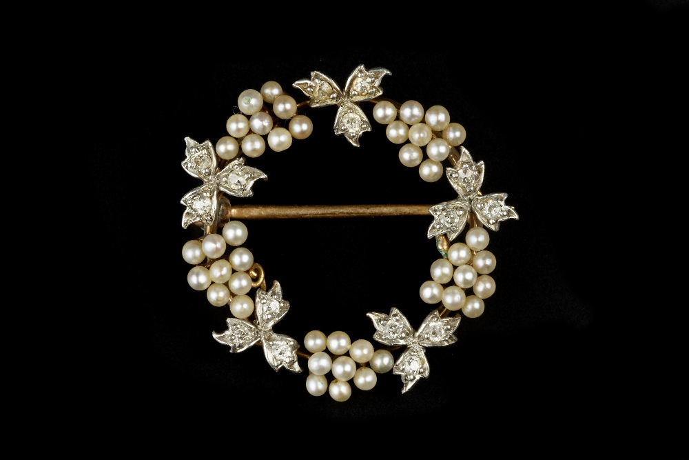 A SEED PEARL AND DIAMOND WREATH BROOCH, modelled as a fruiting vine of seed pearl grape clusters and