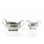 A GEORGE III SILVER TWIN HANDLED SUCRIER AND MATCHING MILK JUG, with gadrooned and scallop cast