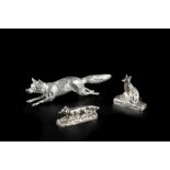 A SILVER MODEL of a running fox, maker's mark indistinct, London, 15.5cm long, 4 oz; and two