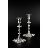 A MATCHED PAIR OF GEORGE III SILVER CANDLESTICKS, with foliate knopped stems, and scroll cast shaped