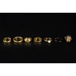 A COLLECTION OF RINGS, comprising a 22ct gold wedding band, an engraved 18ct gold wedding band, a