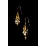 A PAIR OF VICTORIAN EAR PENDANTS, each foliate panel with a trio of pear-shaped white stones in