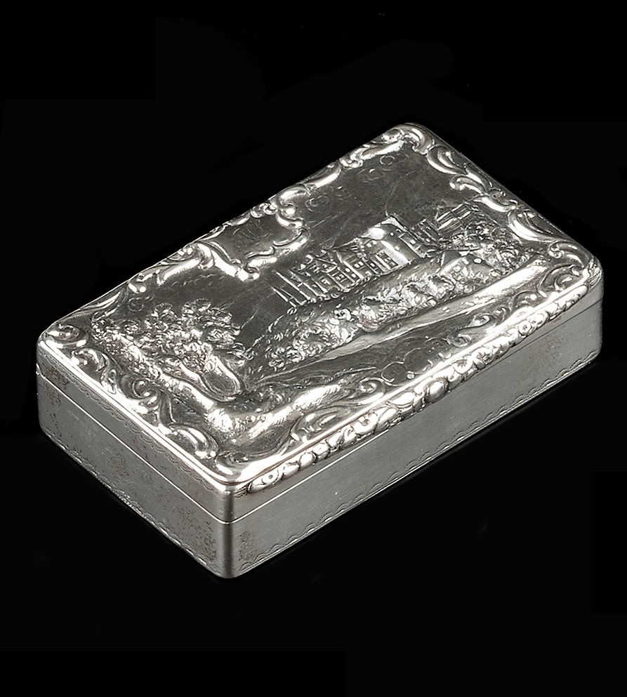 A WILLIAM IV SILVER RECTANGULAR SNUFF BOX, the lid chased and embossed with a country house by a