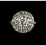 A 19TH CENTURY DIAMOND PANEL RING, the circular panel centred with a cushion-shaped old-cut diamond,