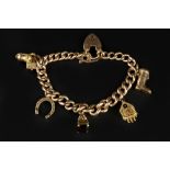 A CHARM BRACELET, the curb-link bracelet stamped '9 .375', with 9ct gold padlock clasp, suspending