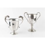 A LATE VICTORIAN SILVER TWIN HANDLED TROPHY CUP, with reeded handles and circular pedestal foot,