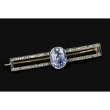 A SAPPHIRE SET PANEL BROOCH, the shaped openwork rectangular panel edged with a blue and white stone