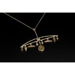 A 9CT GOLD PENDANT NECKLACE, of abstract design, suspending a line of geometric panels, on a trace-