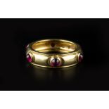 A RUBY BAND RING BY TIFFANY & CO, spaced with circular cabochon rubies in collet settings, yellow