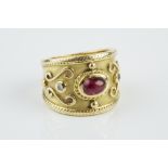 A RUBY AND DIAMOND DRESS RING, the tapered band centred with an oval cabochon ruby and two round