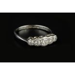 A DIAMOND FIVE STONE RING, the graduated round brilliant-cut diamonds in illusion setting, white