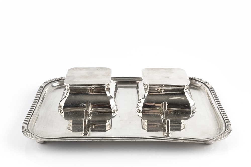 A SILVER INKSTAND, of rounded rectangular form, with reeded border, two lidded inkwells (lacking