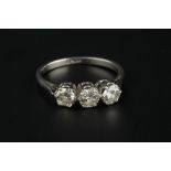 A DIAMOND THREE STONE RING, the round brilliant-cut diamonds in claw setting, white precious metal