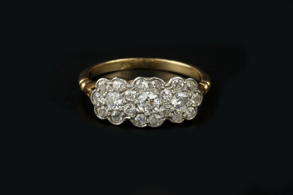 A DIAMOND TRIPLE CLUSTER RING, the graduated brilliant and old-cut diamonds in millegrained setting,