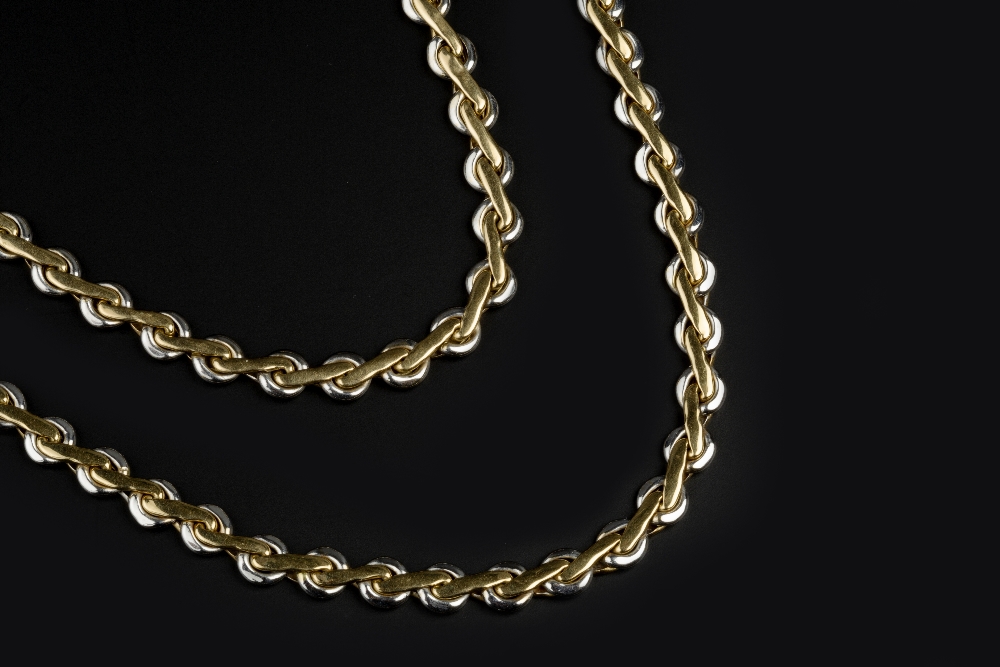 AN 18CT TWO COLOUR GOLD NECKLACE AND BRACELET SUITE, of fancy-link design, maker's mark FA, necklace