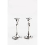 A PAIR OF SILVER CANDLESTICKS, with fluted and tapered columns, on fluted, elongated octagonal