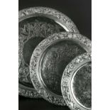 A SET OF THREE GRADUATED LATE VICTORIAN SILVER SALVERS, the pierced borders chased and embossed with