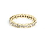 A DIAMOND FULL HOOP ETERNITY RING, set throughout with round brilliant-cut diamonds in part-collet