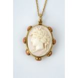 A VICTORIAN CAMEO PENDANT, the oval conch shell cameo carved to depict a classical portrait profile,