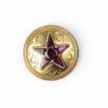 A VICTORIAN GARNET AND DIAMOND SET PANEL BROOCH, the circular panel centred with a star-shaped