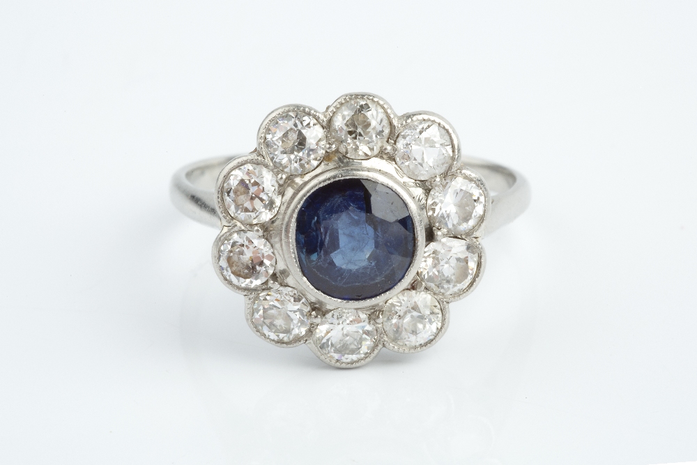 A SAPPHIRE AND DIAMOND CLUSTER RING, the circular mixed-cut sapphire in millegrain collet setting, - Image 2 of 2