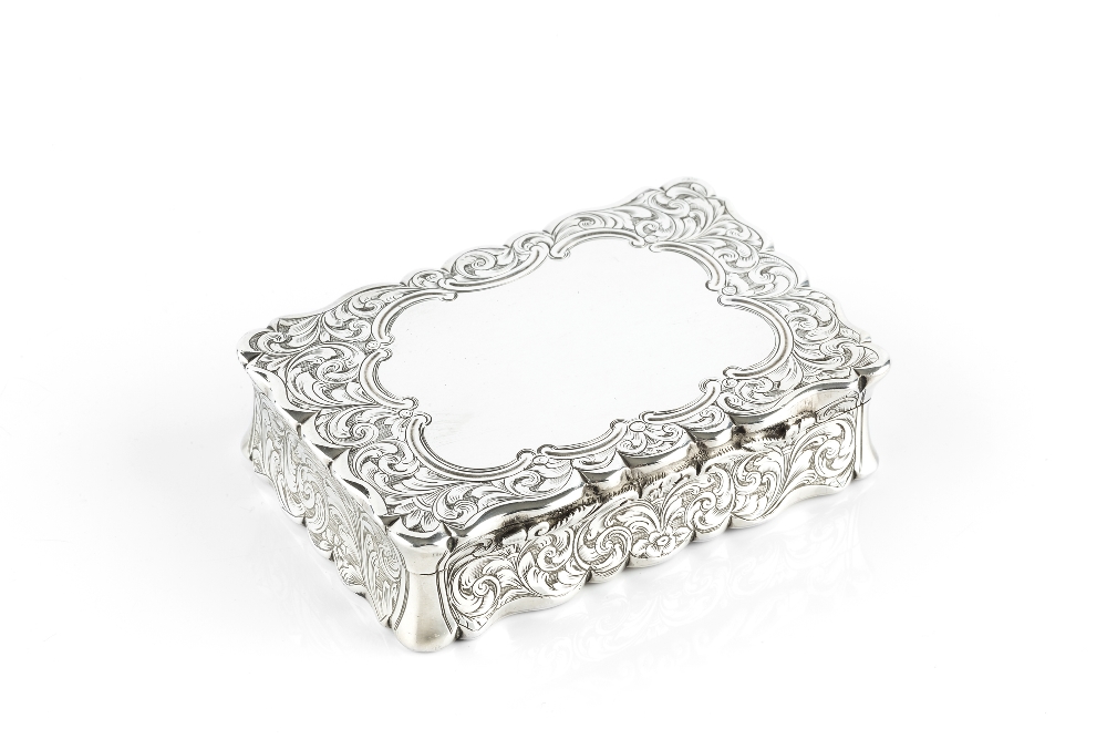 A MID VICTORIAN SILVER RECTANGULAR SNUFF BOX, with shaped concave sided outline engraved with