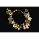 A CHARM BRACELET, the fancy-link bracelet stamped '9c', suspending a collection of assorted 9ct