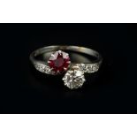 A RED SPINEL AND DIAMOND TWO STONE CROSSOVER RING, the cushion-shaped mixed-cut red spinel and old-