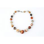 A BANDED AGATE BEAD NECKLACE, the graduated agate beads with faceted spacers between, together