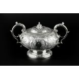 A GEORGE III SILVER TWIN HANDLED SUCRIER AND COVER, embossed with 'C' scrolls and flowering foliage,