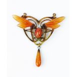 A HORN AND PASTE PENDANT, in the Art Nouveau style, the carved horn dragonfly panel heightened in
