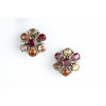 A PAIR OF GEM SET EAR CLIPS, each a cluster of circular mixed-cut gemstones of pink, orange and