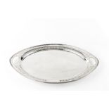 AN EDWARDIAN SILVER NAVETTE SHAPED TWIN HANDLED TRAY, with reeded and pierce decorated border, by