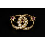A VICTORIAN RUBY AND HALF PEARL PANEL BROOCH, modelled as two entwined crescent moons of graduated