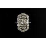 AN EARLY 20TH CENTURY DIAMOND PANEL RING, the pierced and millegrained panel set throughout with