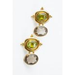A PAIR OF GEM SET EAR PENDANTS, each designed as an oval mixed-cut peridot in collet setting, with