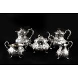 A LATE VICTORIAN SILVER FIVE PIECE TEA AND COFFEE SERVICE, repoussé decorated with flowers and