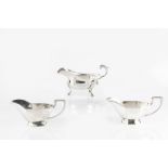 AN EDWARDIAN SILVER SAUCE BOAT, with scroll handle and shell capped hoof feet by C.S. Harris &