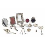 A GROUP OF SILVER ITEMS TO INCLUDE: five various small photo frames, two tea strainers, a pair of