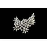 A DIAMOND SPRAY BROOCH, designed as an abstract foliate spray, with graduated round brilliant and