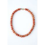 A CORAL BEAD NECKLACE, the single strand of slightly graduated coral corallium rubrum beads with