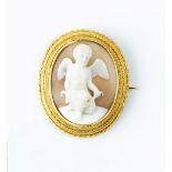 A VICTORIAN OVAL SHELL CAMEO BROOCH, carved to depict Cupid holding a bow, within a ropetwist