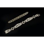 AN ART DECO STYLE PASTE PANEL BRACELET, comprising a line of repeating geometric openwork panels