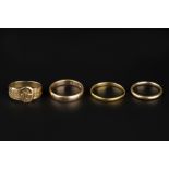 A COLLECTION OF RINGS, comprising a 9ct gold buckle ring, with scrolled decoration, a 22ct gold