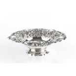 A MID VICTORIAN SILVER PEDESTAL BOWL, the borders chased and embossed with flowers and fruiting