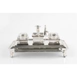 AN ITALIAN INKSTAND, of shaped rectangular form, fitted with a central miniature chamberstick