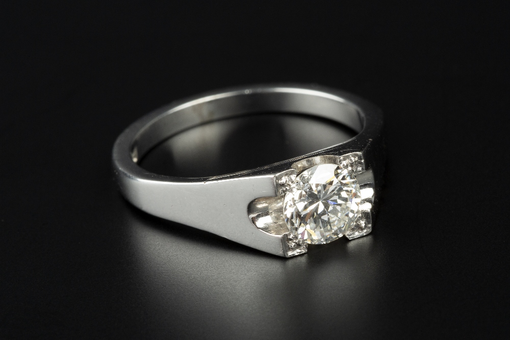 A DIAMOND SINGLE STONE RING, the round brilliant-cut diamond in square setting with beaded